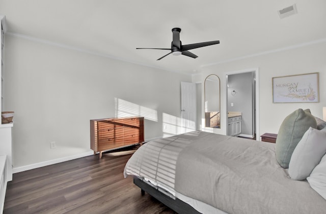 bedroom with dark wood-type flooring, visible vents, baseboards, ornamental molding, and ensuite bath