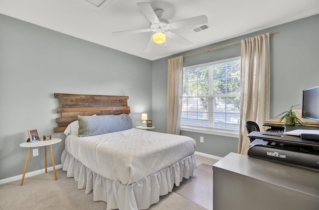 bedroom featuring baseboards, ceiling fan, visible vents, and light colored carpet