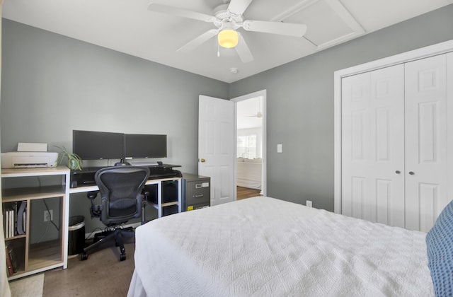 bedroom with ceiling fan, attic access, and a closet