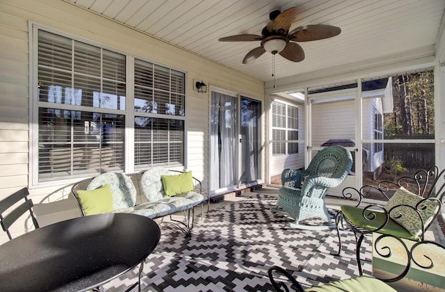 sunroom with wooden ceiling and ceiling fan