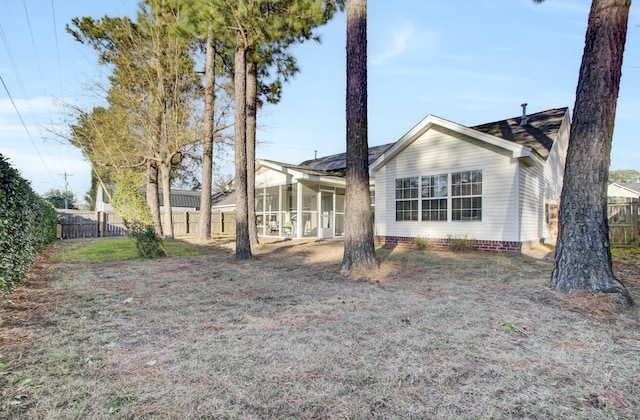 rear view of house featuring crawl space and fence