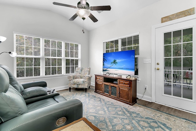 living room featuring lofted ceiling, ceiling fan, and wood-type flooring