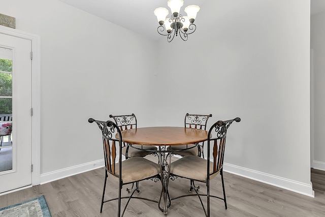 dining space with an inviting chandelier and hardwood / wood-style floors