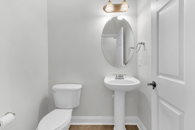 bathroom featuring tile patterned flooring, sink, and toilet