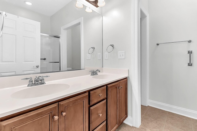 bathroom with toilet, vanity, tile patterned flooring, and a shower with shower door