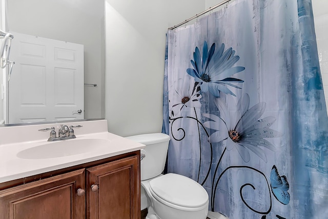 bathroom featuring toilet and vanity