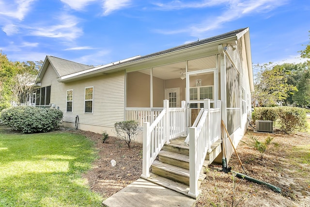 view of front of house featuring a front lawn and central air condition unit