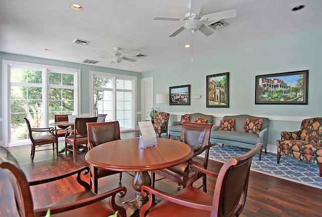 dining area with ceiling fan, dark hardwood / wood-style floors, and a textured ceiling