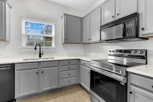 kitchen featuring black appliances, sink, and gray cabinets