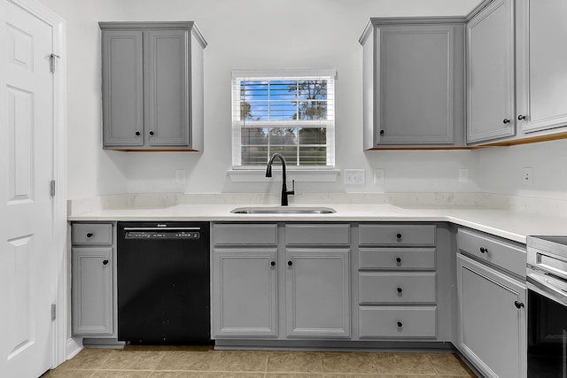 kitchen with gray cabinetry, sink, and black dishwasher