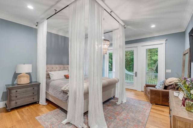 bedroom with ornamental molding, light hardwood / wood-style floors, and access to outside