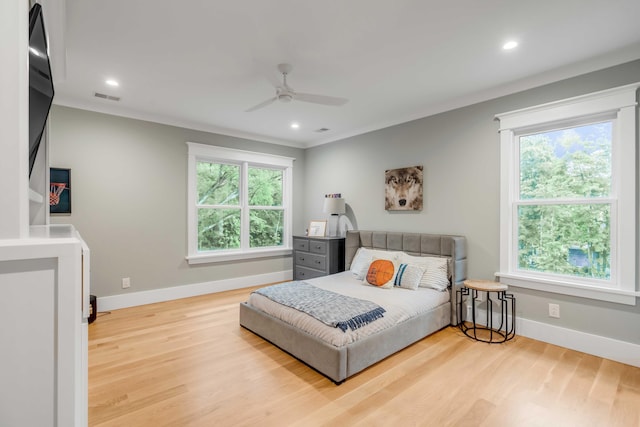 bedroom with ceiling fan, light wood-type flooring, and ornamental molding