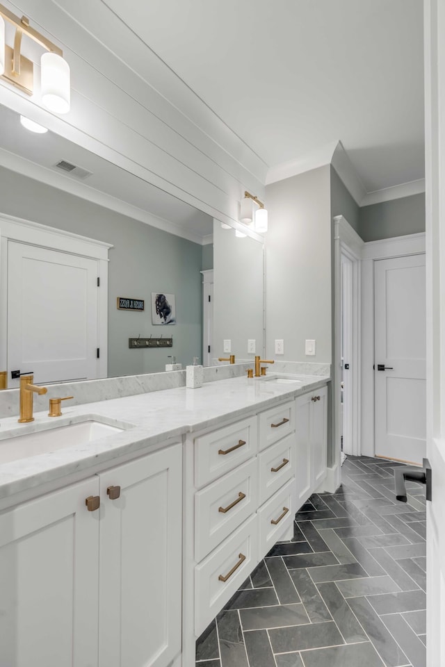 bathroom with double vanity, tile flooring, and crown molding