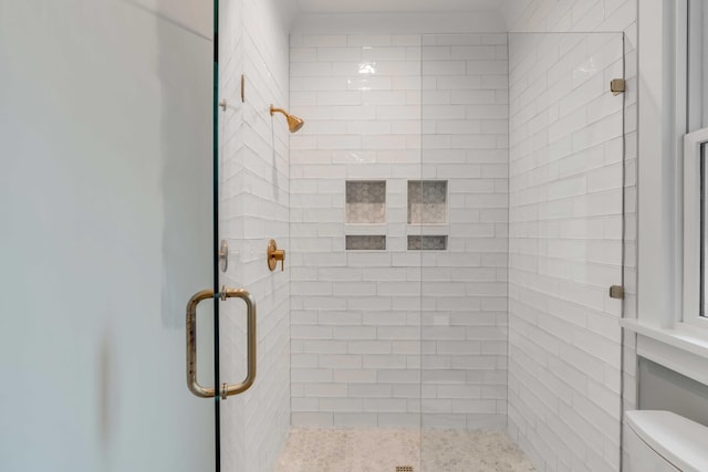 bathroom with walk in shower and toilet