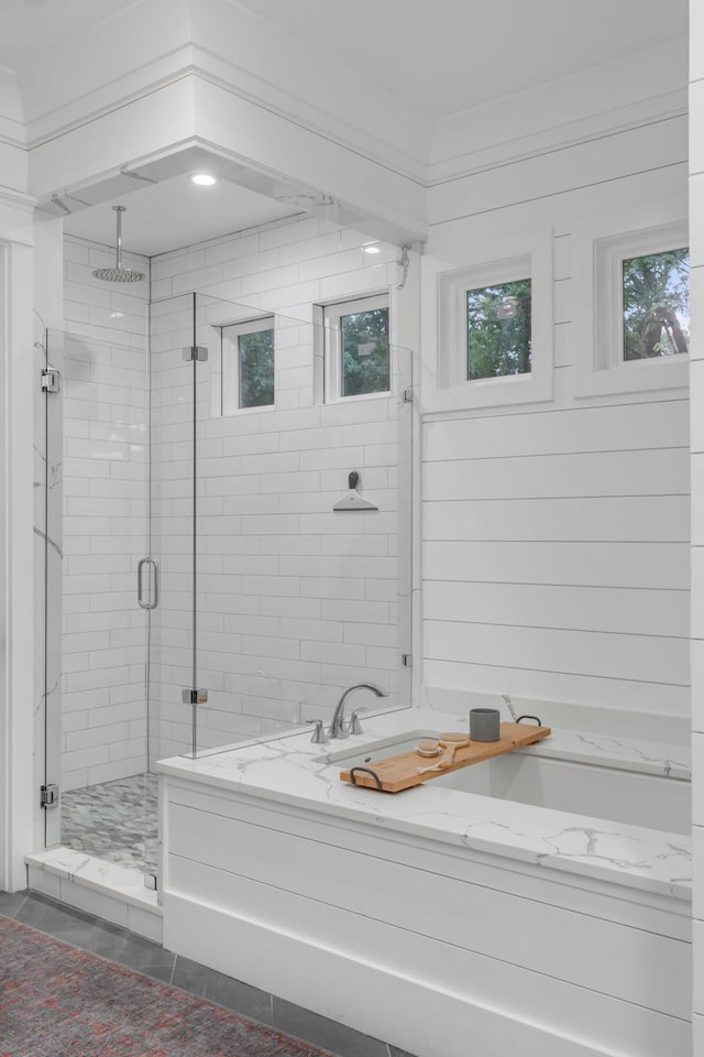 bathroom featuring tile floors and plus walk in shower