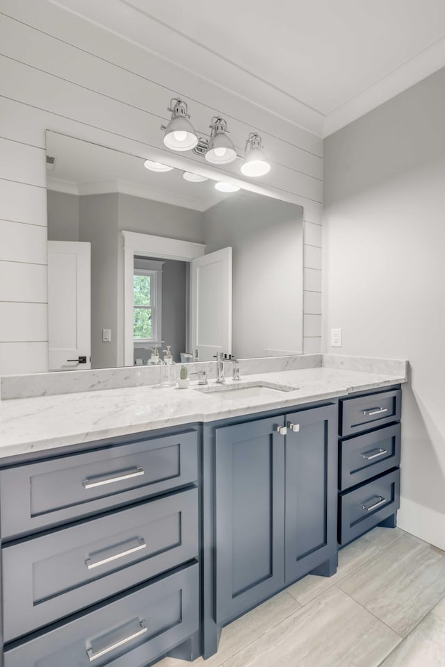 bathroom with crown molding and vanity