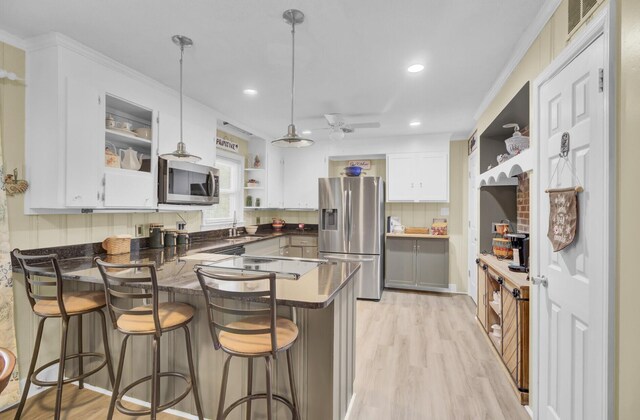 dining space with ceiling fan, wooden walls, and carpet flooring