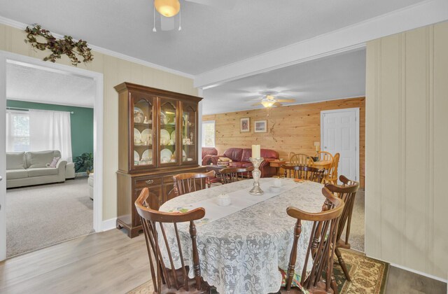 kitchen with light wood-type flooring, white cabinets, ceiling fan, and stainless steel fridge