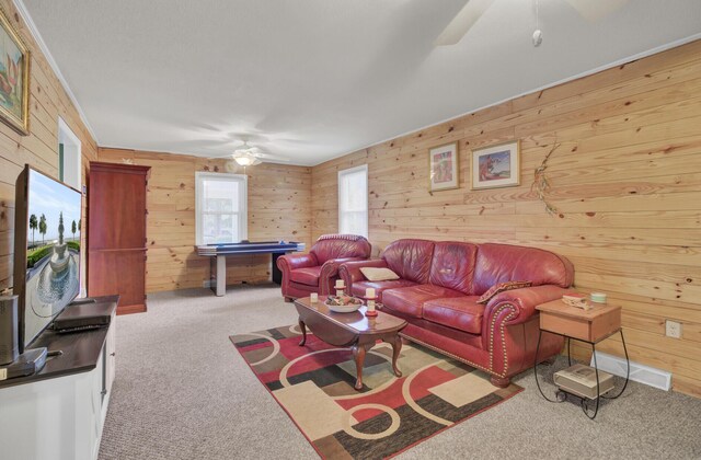 living room featuring a textured ceiling, crown molding, and carpet flooring