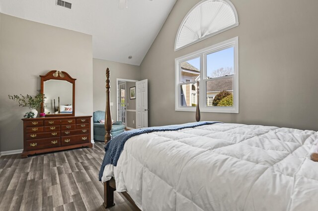 bedroom with high vaulted ceiling, baseboards, visible vents, and dark wood-style flooring