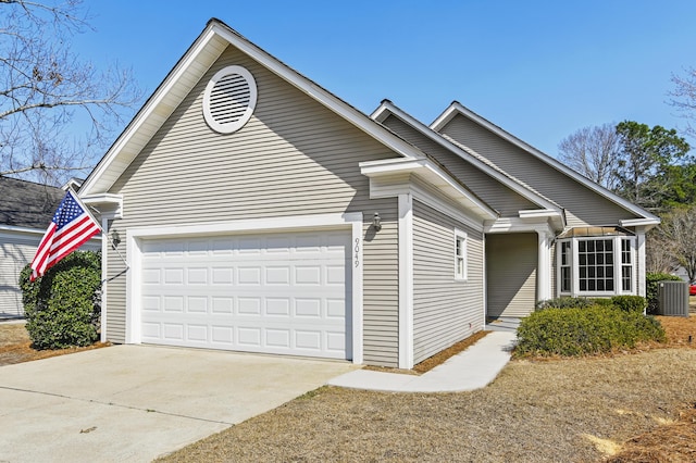 ranch-style home with a garage, cooling unit, and concrete driveway