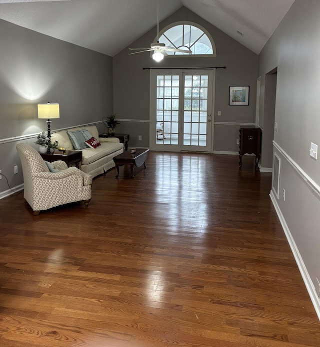 living area featuring vaulted ceiling, wood finished floors, a ceiling fan, and baseboards