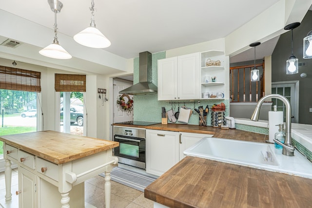 2650 Summer Leaves Ct, Charleston, SC 29414 - kitchen featuring butcher block counters, wall chimney range hood, stainless steel oven, a sink, and open shelves