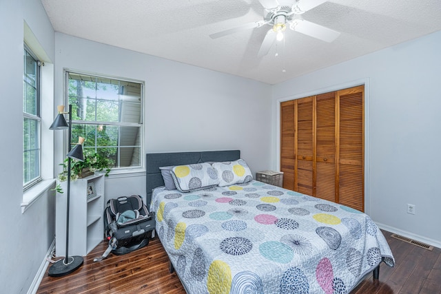 2650 Summer Leaves Ct, Charleston, SC 29414 - bedroom featuring wood finished floors, multiple windows, a closet, baseboards, and a textured ceiling