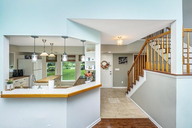 2650 Summer Leaves Ct, Charleston, SC 29414 - kitchen with freestanding refrigerator, a sink, decorative light fixtures, baseboards, and tile patterned floors