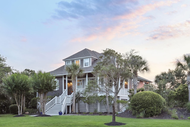 view of front of home featuring a lawn and covered porch