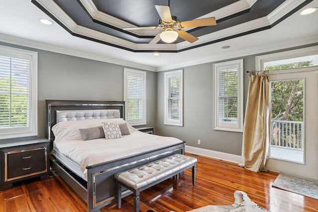 bedroom featuring ornamental molding, multiple windows, dark wood-type flooring, and ceiling fan