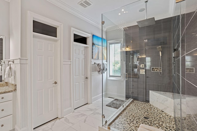 bathroom with crown molding and a shower with shower door