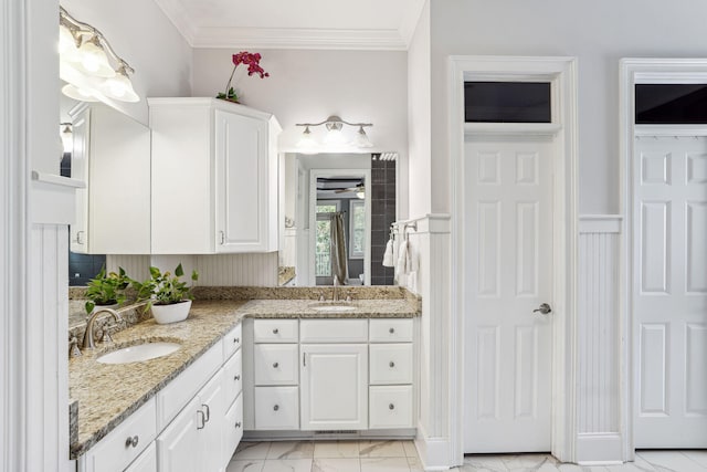 bathroom with vanity, ceiling fan, and crown molding