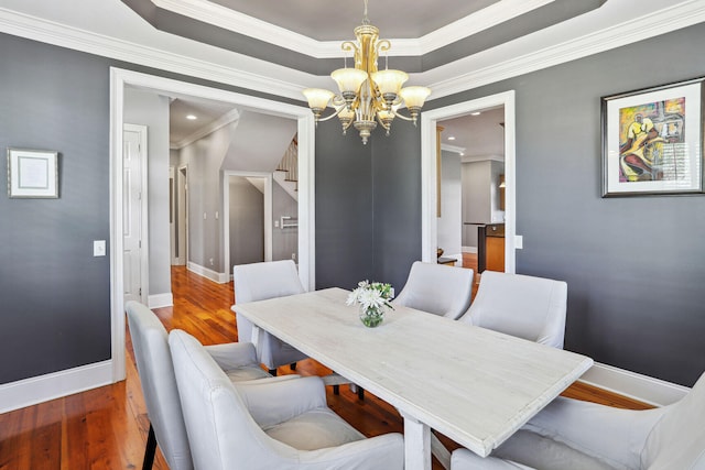 dining room featuring hardwood / wood-style flooring and crown molding