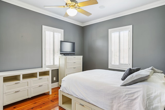 bedroom featuring ceiling fan, dark hardwood / wood-style flooring, and ornamental molding