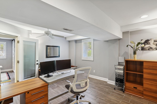 office area with ceiling fan and dark wood-type flooring