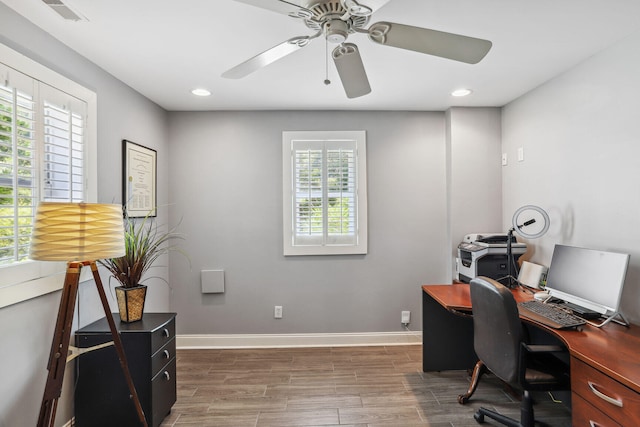 office space with dark hardwood / wood-style flooring, ceiling fan, and plenty of natural light