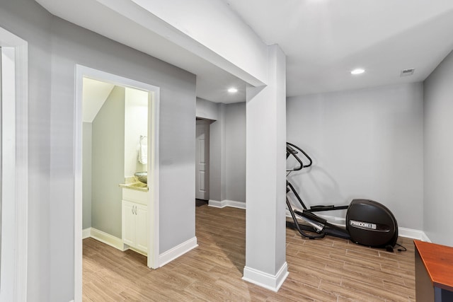 exercise room featuring light hardwood / wood-style flooring