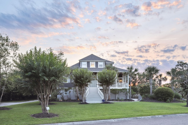 view of front of property featuring a porch and a lawn