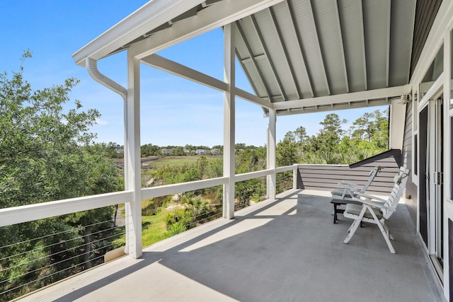 sunroom / solarium featuring lofted ceiling