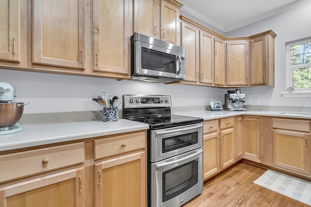 kitchen with crown molding, light brown cabinetry, light wood-type flooring, and appliances with stainless steel finishes