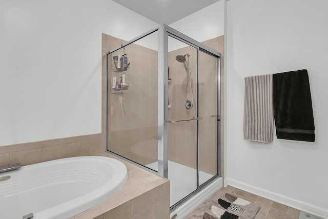 bathroom with tile patterned floors and independent shower and bath