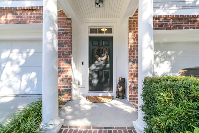 doorway to property with a garage