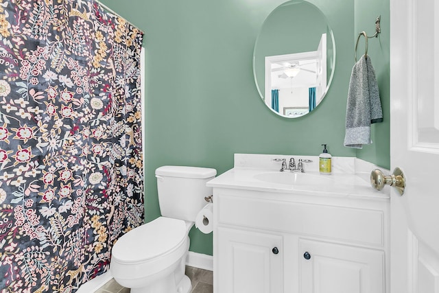 bathroom featuring tile patterned floors, vanity, and toilet