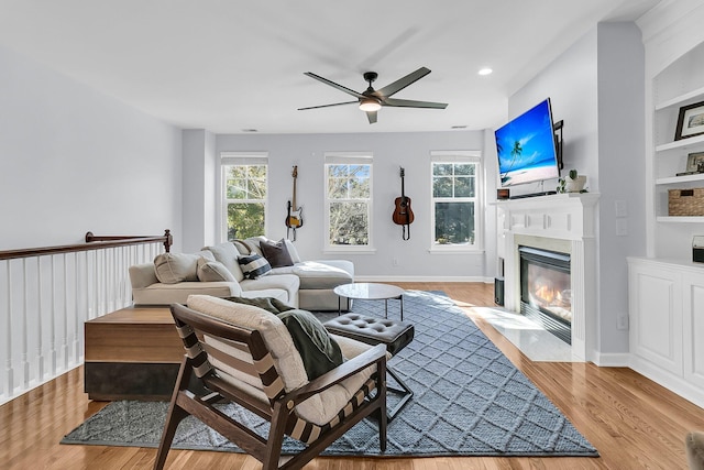 living room with ceiling fan and light wood-type flooring