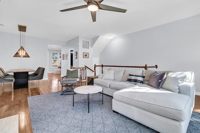 living room featuring hardwood / wood-style flooring and ceiling fan