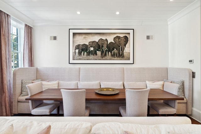 dining room with breakfast area and crown molding