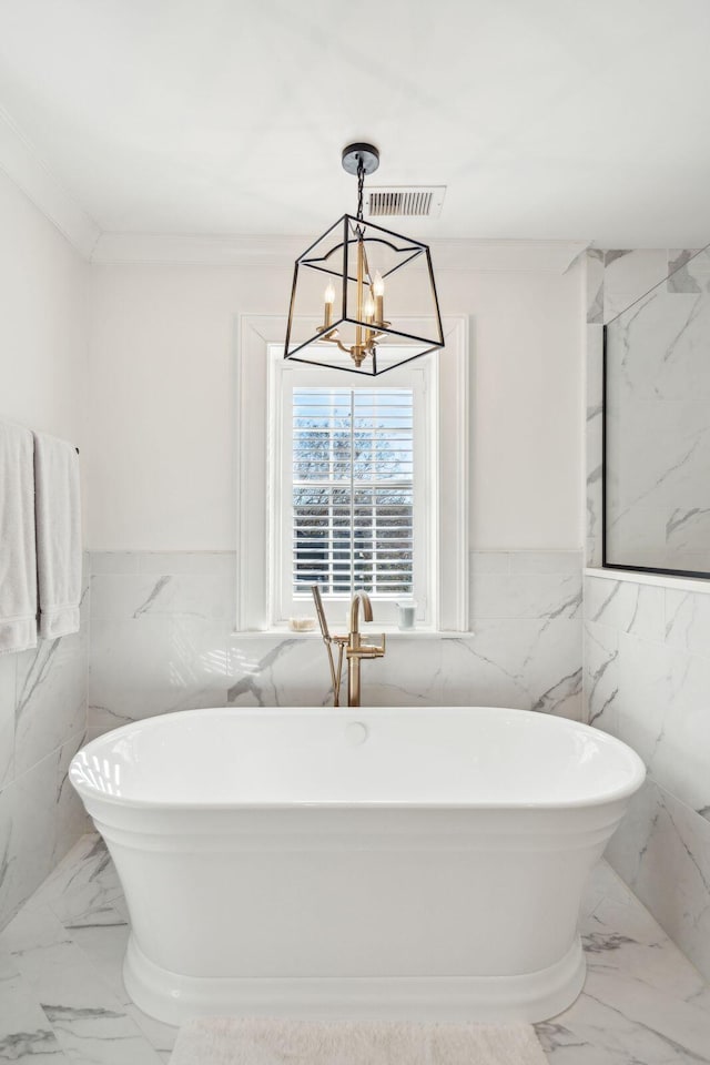 bathroom featuring crown molding, a bath, tile walls, and a notable chandelier