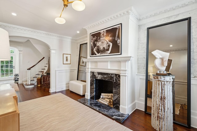 interior space with crown molding, a premium fireplace, and dark hardwood / wood-style floors