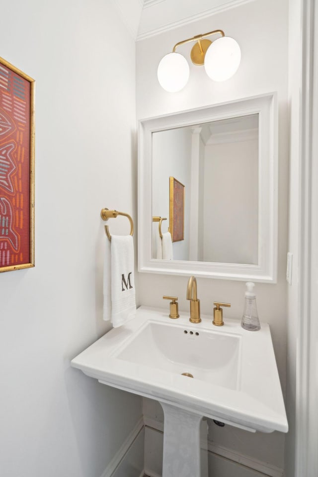 bathroom featuring ornamental molding and sink